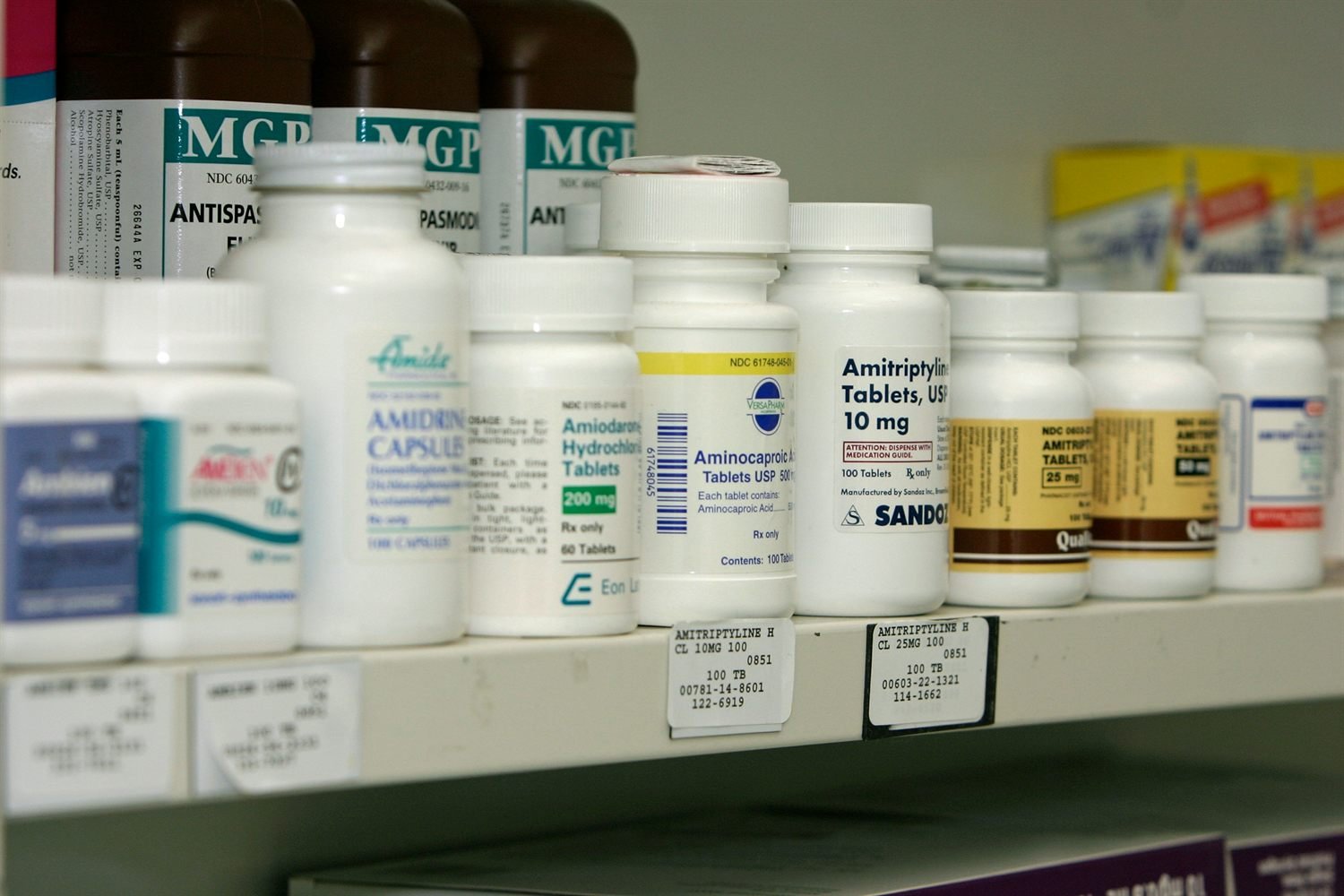 A hand writing on a prescription pad